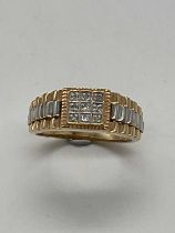 A yellow metal gentleman's diamond set ring with 'Rolex' inspired detail to the shoulders, size T,
