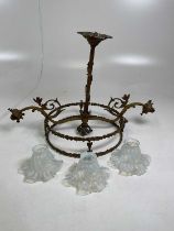 An early 20th century gilt light fitting with three glass shades.