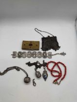 A group of jewellery including coral beads, silver bracelet, silver purse etc.