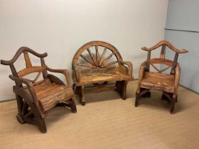 A rustic wooden garden set constructed from cart wheels and comprising two chairs and a two-seat