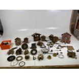 A quantity of clock parts together with a quantity of empty cases for Cuckoo clocks, weights etc.
