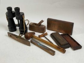 A pair of Bino Prism No 5 binoculars with various tools and a copper printing block.