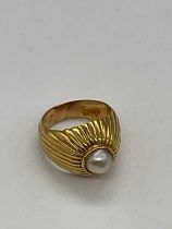 A yellow metal pearl set domed ring, size M, approx 8.4g.