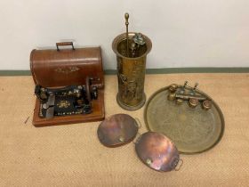 A Singer sewing machine and various copper and brassware.