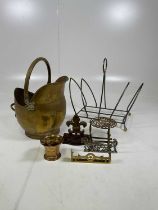 A brass mortar and pestle, coal bucket, magazine rack, door stop and trivet.