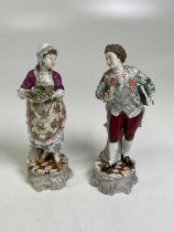 A pair of Continental porcelain figures, boy with flower and girl with tray of fruit, height 25cm.