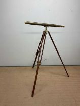 A reproduction brass telescope on tripod stand, height of fully extended tripod 132cm, length of