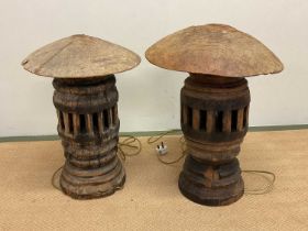 A pair of rustic wooden lamps constructed from cart wheel spindles, height 52cm.