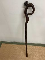 An early 20th century Trobriand Islands carved stick, length 106cm.