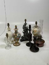 Seven various lamp bases, an oil lamp and an oak barley twist candlestick, tallest lamp 33cm.