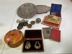 An assortment of collectables including an Afghan spice tin, plated trays, jigsaws, books and