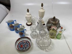 A collection of ceramics and glassware including jugs, table lamps, decanters, a Chinese jar etc.