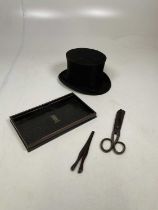 A vintage French silk collapsible opera hat, an Edwardian desk tidy, a pair of glove stretchers