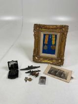 A collection of medals, photos and some military items including a framed pair of WWI medals to 7176