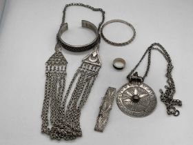 A small group of Omani silver jewellery including a circular pendant on chain, necklace, bangle,