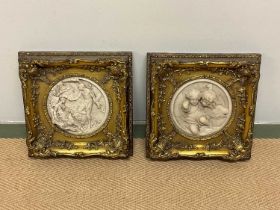 A pair of reproduction circular plaques, diameter 18cm, frame 30 x 30cm.