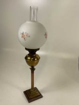 A brass Corinthian column oil lamp with opaque shade, height including chimney 70cm.