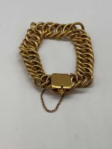 A Middle Eastern heavy yellow metal bracelet stamped 875 with peg clasp and safety chain, approx