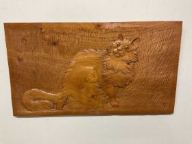A carved oak plaque shaped in the form of a cat, 65 x 36cm.