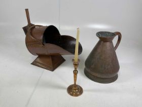 A copper coal coal scuttle on square base together with a two gallon jug and candlestick.