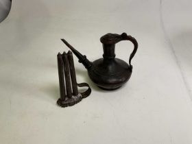 A 19th century metal candle mould, height 24cm, and a Persian style copper water vessel, height
