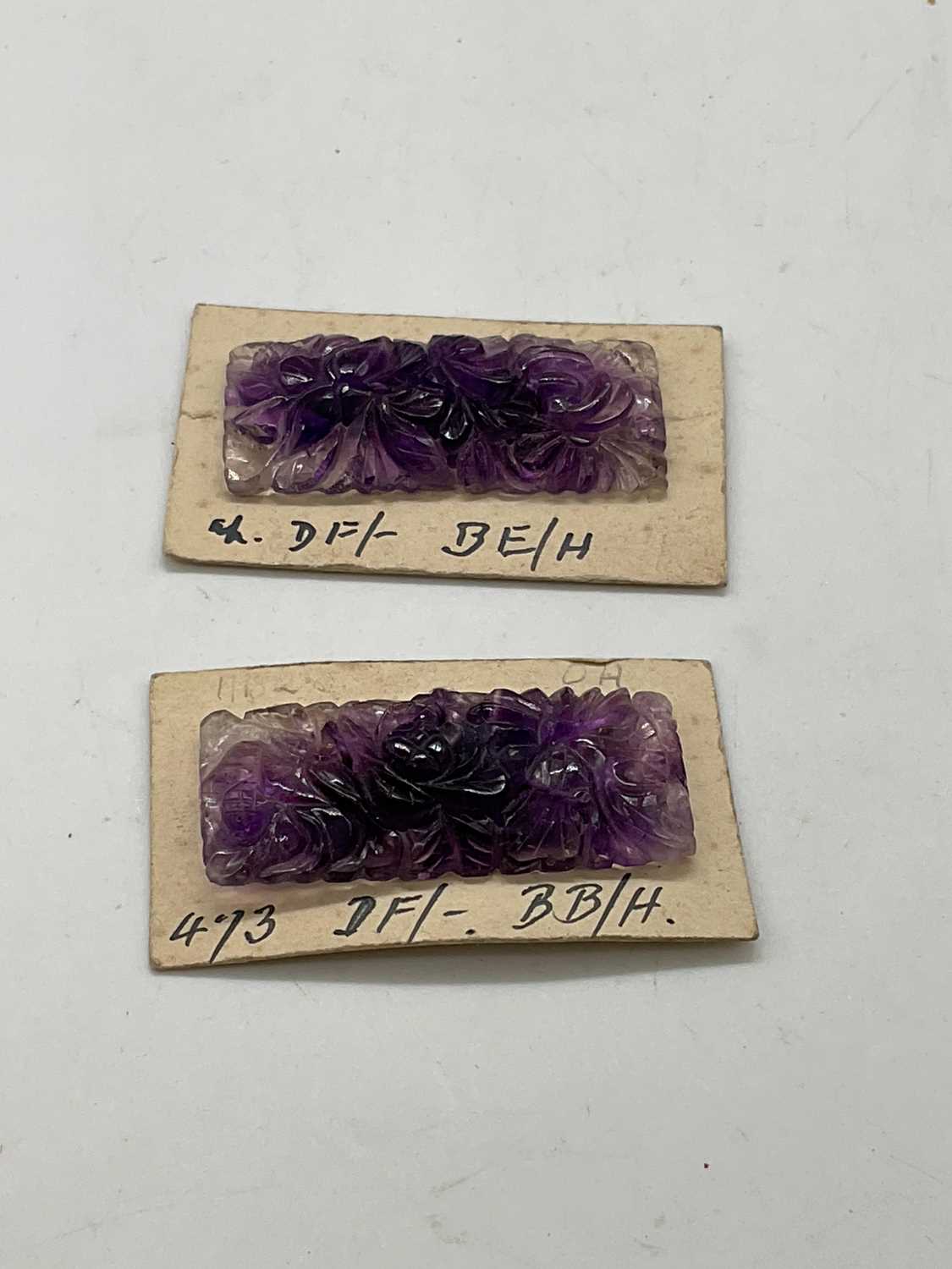 An unusual pair of floral carved amethyst plaques mounted on card, 36 x 18mm. - Image 2 of 2