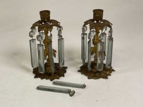 A pair of gilt over brass table lustres, with facet cut glass drops, height 21cm.