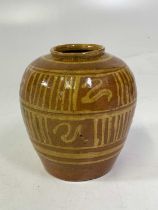 An early 20th century slipware pottery vase decorated with vertical and horizontal lines, height