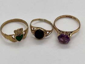 Three 9ct yellow gold dress rings, one with green enamelled heart detail, size Q, approx 5.7g.