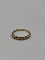 An 18ct yellow gold and diamond set half eternity ring with eleven small round brilliant cut