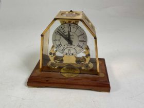 A Michael's 21st Century Millennium 2000 brass skeleton clock, with glazed and brass case and oak