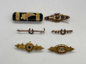 Six Edwardian yellow metal brooches, one set with nephrite jade.