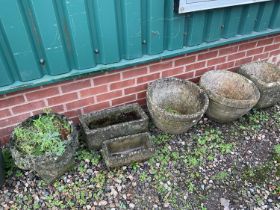 Six concrete garden planters.