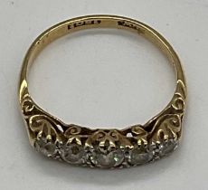 An Edwardian 18ct yellow gold and five stone graduated diamond set ring, the largest central old cut