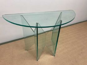 A good quality contemporary glass demi-lune hall table raised on unusually shaped thick glass