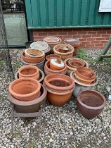 A large quantity of glazed and terracotta garden pots, a cast iron boot scraper and an iron trellis
