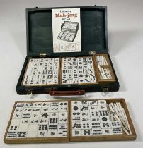 A cased Mahjong set, together with a Discovering Mahjong booklet