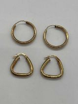 A pair of 9ct yellow gold triangular shaped earrings and a pair of yellow metal hoop earrings,
