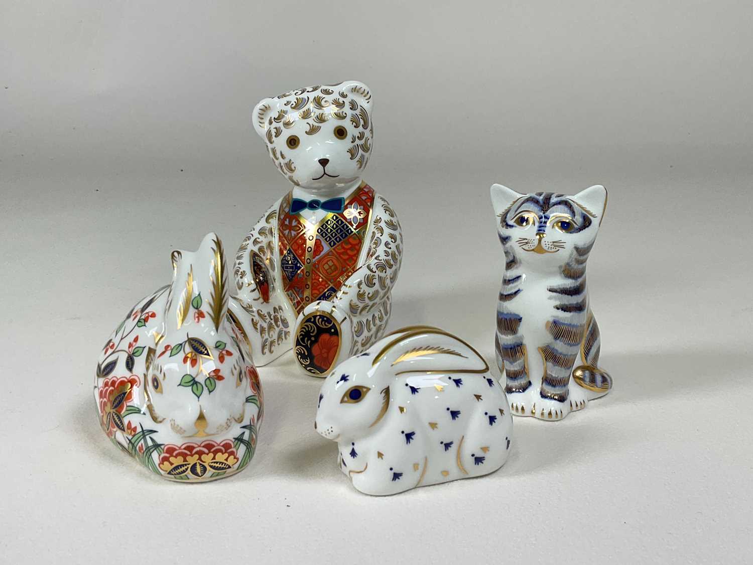 ROYAL CROWN DERBY; four boxed paperweights with gold stoppers, 'Seated Teddy Bear' height 12cm, '
