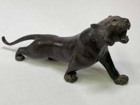 Japanese Meij period bronze figure of a tiger, signed to belly, length 29cm.