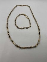 A 9ct yellow and white gold necklace and matching bracelet, length of necklace 46cm, length of