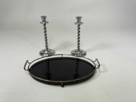 An Art Deco oval black glass cocktail tray with silver plated frame and a pair of chrome barley