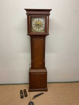 An early 19th century oak and mahogany crossbanded eight day longcase clock, the brass dial set with