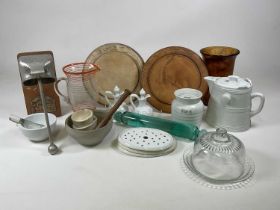 A quantity of kitchenalia including glass rolling pin, pestle and mortars, storage jar, glass cheese