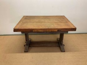 An Arts and Crafts oak extending table with plank top, height 71cm, width 114cm, extended width