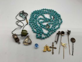 A string of turquoise beads, various small charms, a Scottish hardstone set brooch etc.