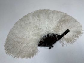 A 1920s/30s feather fan with tortoiseshell sticks, length approx 36cm.