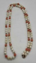 A vintage coral and stained coral bead necklace set with 9ct gold clasp and yellow metal spacers,