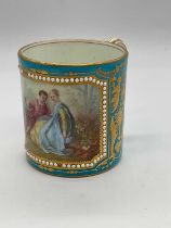 SEVRES; an 18th century porcelain coffee can with Bleu Celeste ground and rectangular vignette