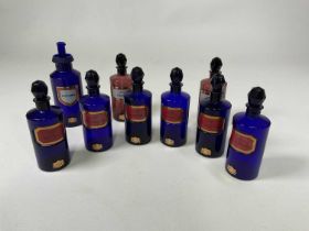 Nine 20th century Bristol blue glass apothecary poison bottles, all with ground rim stoppers, height